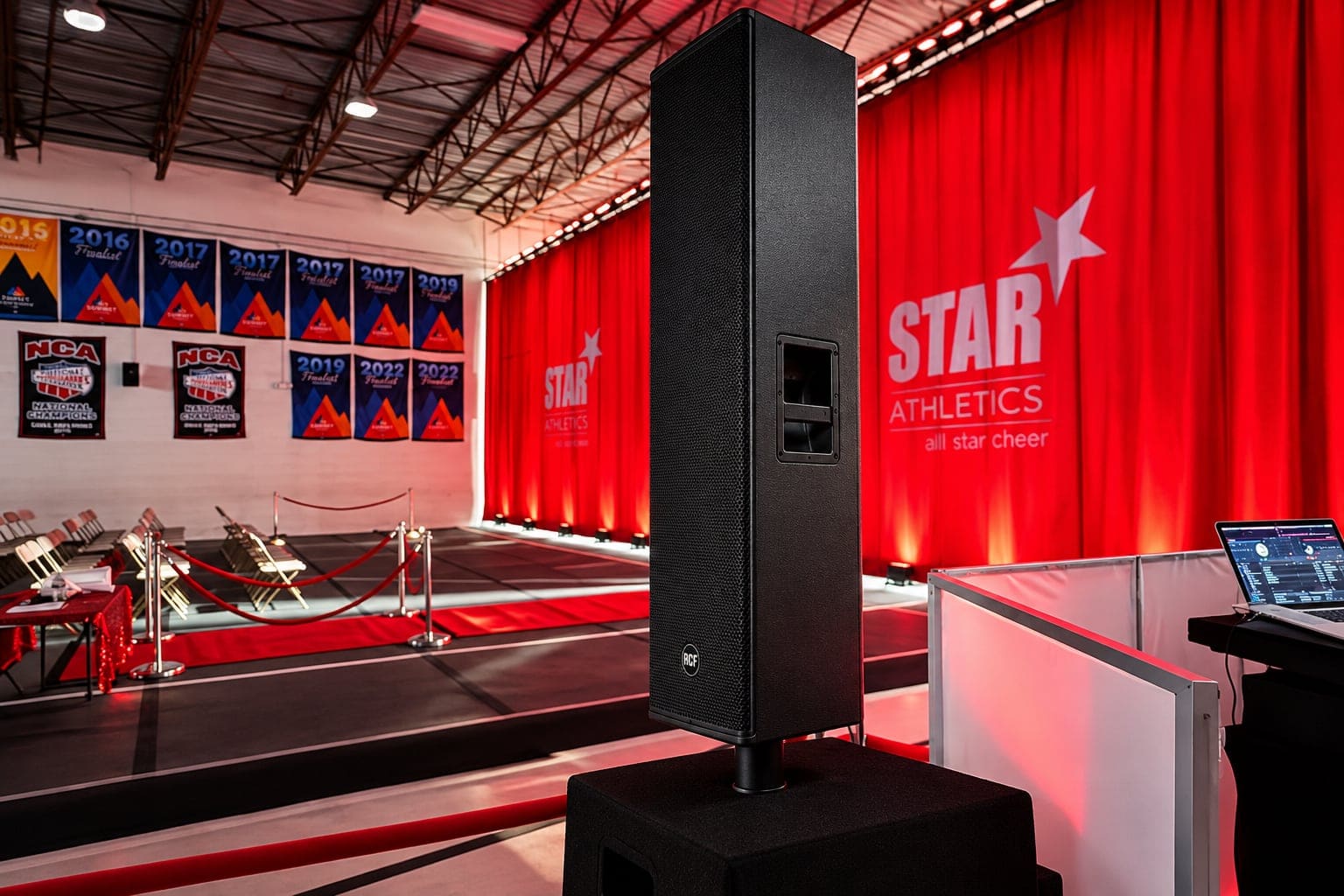 Cheerleading competition floor with large-group sound system set up for the event